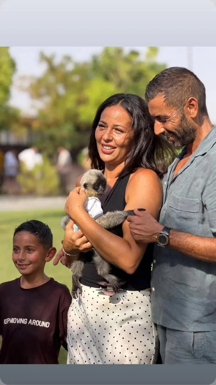 A family meets a young primate at Noor Jungle